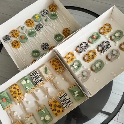 Boxes of animal-print themed cake pops, krispie squares and pretzels.
