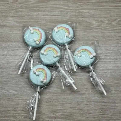 Blue rainbow-decorated Oreo pops in cellophane.
