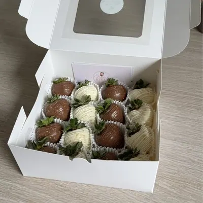 A box of milk and white chocolate strawberries.